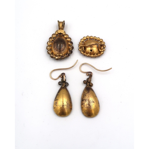 113 - A suite of mid 19th century red stone, likely quartz jewellery, comprising foil backed pendant earri... 