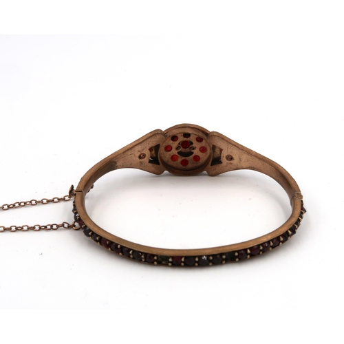 114 - A 19th century garnet set bangle, on rolled gold, internal diameter, 49 by 61.6mm, 17.1g total weigh... 