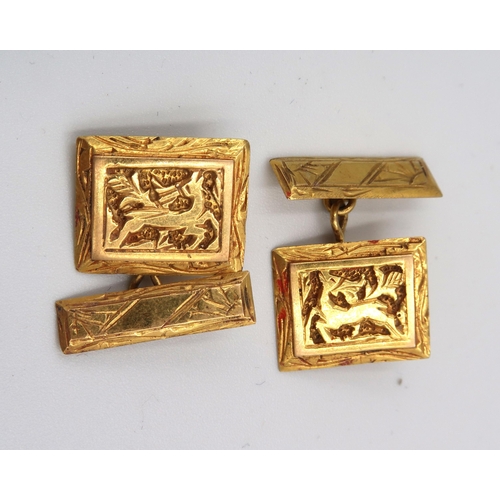 122 - A pair of decorative panel cufflinks. Stamped K18. Weight 8.88 grams.