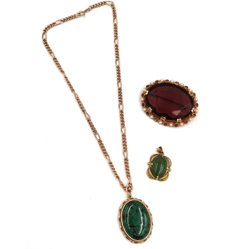 124 - An oval green stone pendant stamped 14K. Weight 10.73 grams. Suspended from a 9ct gold chain weight ... 