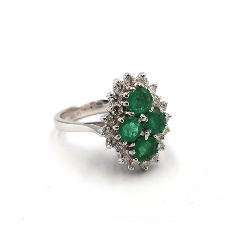 150 - An emerald and diamond dress ring, the central emerald quatrafoil cluster surrounded by diamond bril... 