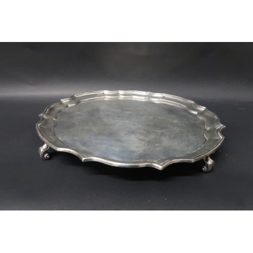 332 - A hallmarked silver salver on tripod feet, 25cm diameter, engraved, weight approx 19.1 troy oz