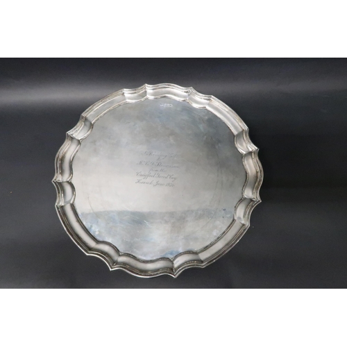 332 - A hallmarked silver salver on tripod feet, 25cm diameter, engraved, weight approx 19.1 troy oz