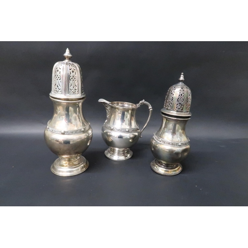 333 - A hallmarked matching set of silver jug and two silver shakers, tallest 19cm, total weight approx 18... 