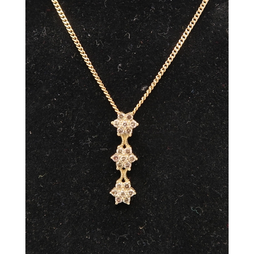 28 - A 9ct yellow gold three star diamond cluster drop pendant on a 9ct gold chain, pendant approx 24mm l... 