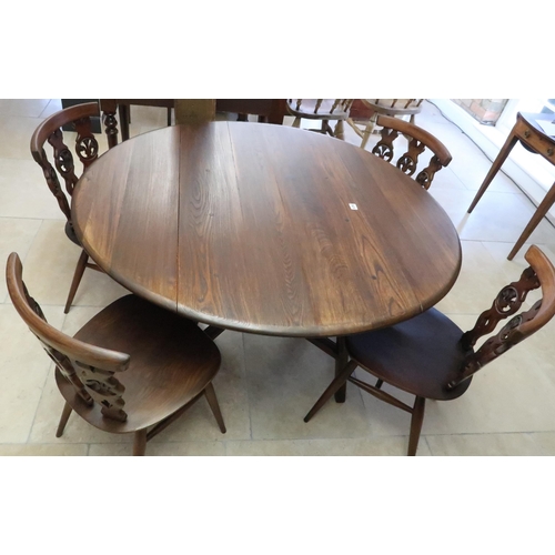 678 - A dark Ercol elm drop flap dining table and four matching Ercol chairs, table 106cm wide x 72cm high... 