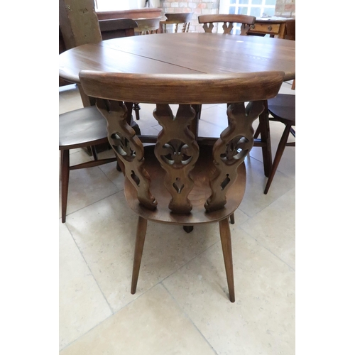 678 - A dark Ercol elm drop flap dining table and four matching Ercol chairs, table 106cm wide x 72cm high... 