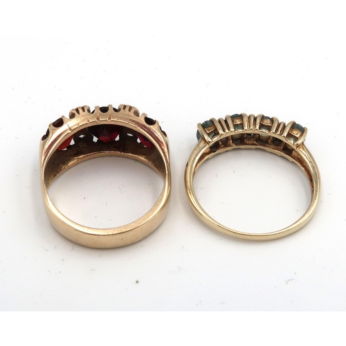  Two dress rings to include garnet and white stone, size O 1/2 and a green stone half eternity size R... 