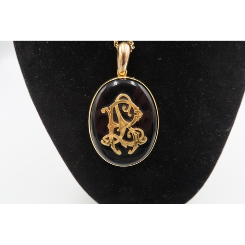  A Victorian jet and diamond mourning pendant, the stylised initials to the front of G, C and J, set ... 