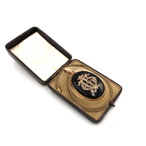  A Victorian jet and diamond mourning pendant, the stylised initials to the front of G, C and J, set ... 