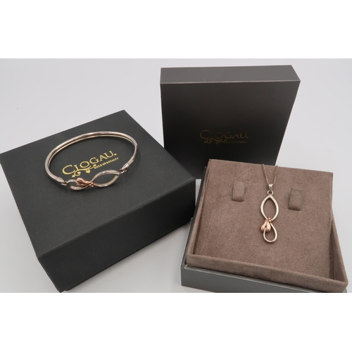 11 - A Clogau bi-colour silver bangle and matching pendant. Weight 19.37 grams