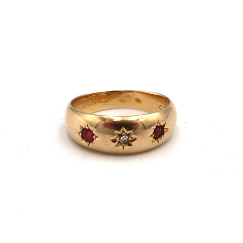 15 - An 18ct gold diamond and red stone gypsy set three stone ring. Size K. Weight 2.01 grams