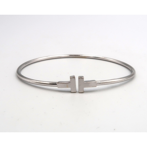 44 - An 18ct White Gold T Bangle, Internal Diameter approx. 56mm x 52mm