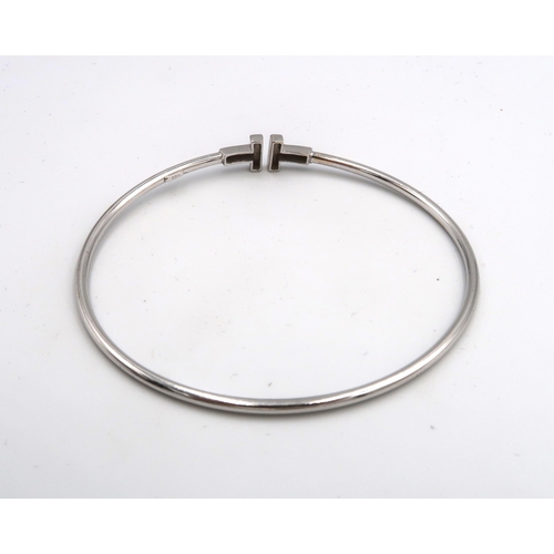 44 - An 18ct White Gold T Bangle, Internal Diameter approx. 56mm x 52mm