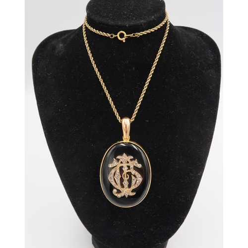 7 - A Victorian jet and diamond mourning pendant, the stylised initials to the front of G, C and J, set ... 