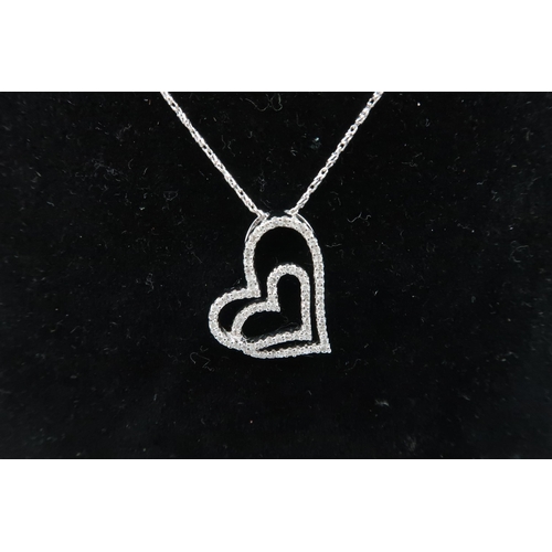 71 - A 14ct white gold double heart pendant set with diamond chiips on 14ct white gold chain, both marked... 