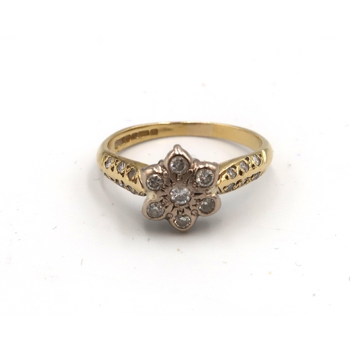 72 - An 18ct gold and diamond flowerhead ring, set with seven illusion set diamonds, each approximately 0... 