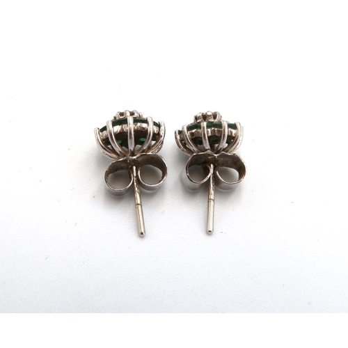 84 - A pair of vintage 18ct white gold, diamond and emerald earrings of flowerhead form, the central diam... 