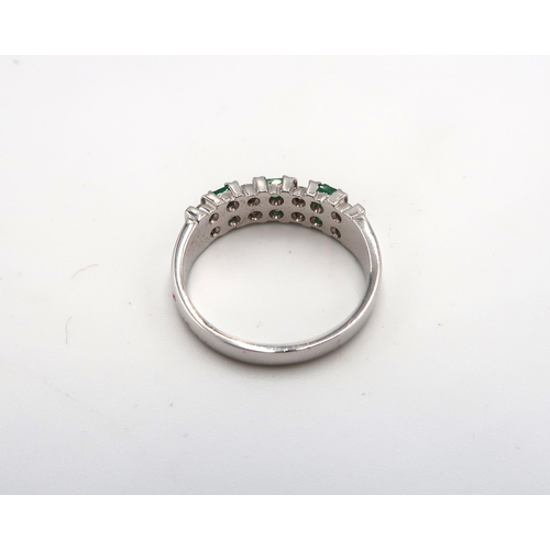 85 - An 18ct white gold, emerald and diamond half eternity, seven stone ring of mid century brutalist sty... 