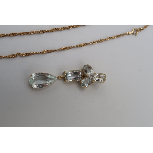 110 - An aquamarine and diamond drop pendant. Length 47mm. Stamped 18k. Weight 5.87 grams. Together with a... 