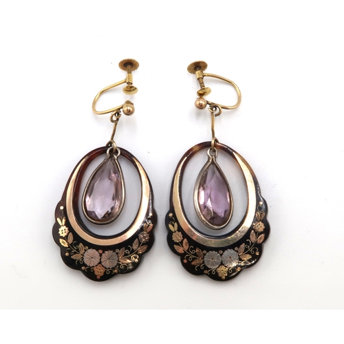 112 - A pair of tortoiseshell earrings with pear shape amethyst central drops. Stamped 9ct. Weight 5.38 gr... 