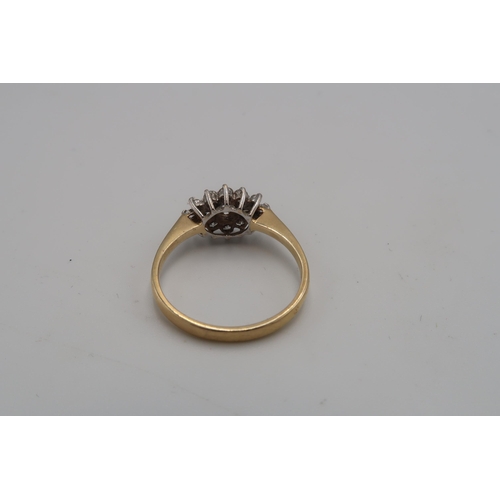 117 - A 14ct gold and cubic zirconia dress ring of flowerhead and leaf form, size P, 2.3g.