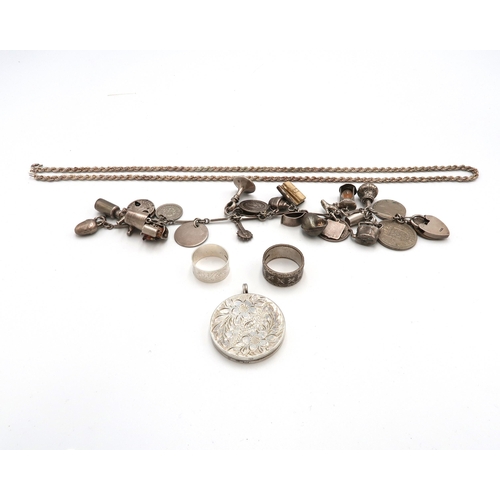 139 - A selection of silver jewellery to include a silver charm bracelet, silver chain, locket and two rin... 