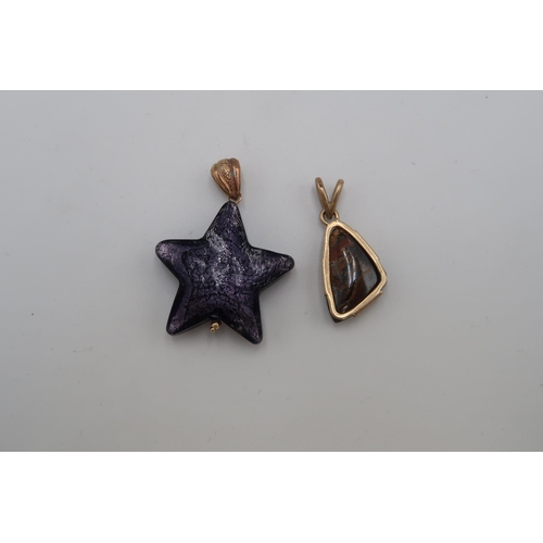 157 - A 9ct gold set pendant with opal striated stone, 3.0g, and a purple glass star pendant, possibly Mur... 