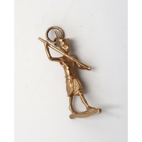 159 - A 9ct gold pendant modelled as an Egyptian pharoah with staff, 3.9g.