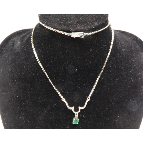 160 - A 9ct white gold diamond and emerald set necklace, with guilloche links to a scroll setting with sin... 