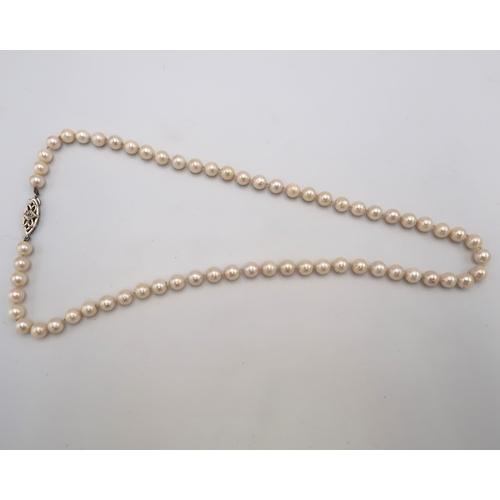 167 - A string of pearls with diamond set 9ct gold clasp, length 51cm, 28.7g.