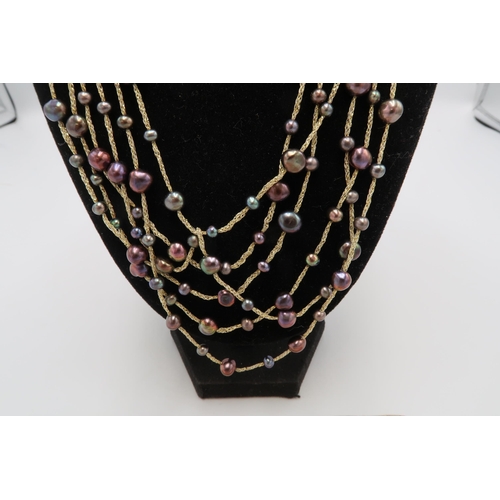 179 - A grey pearl set multistrand necklace, on soft silk to create waterfall effect with 14ct gold clasp,... 