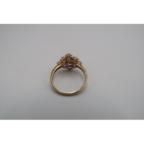 194 - A 9ct gold pink sapphire and diamond cluster ring. Size P 1/2. Weight 2.57 grams.