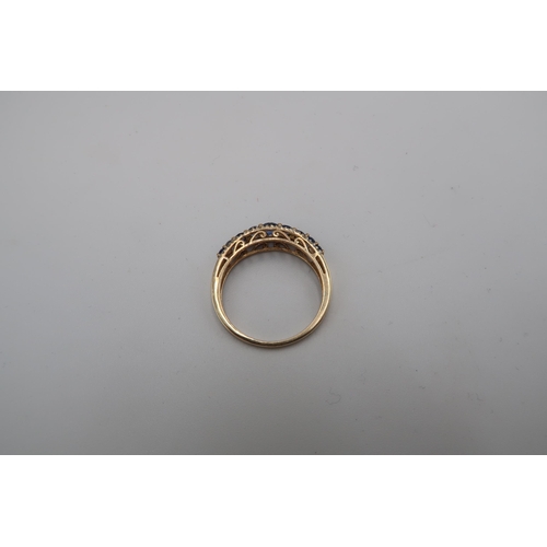 195 - A 9ct gold sapphire and diamond graduated half eternity ring. Size Q 1/2. Weight 2.13 grams