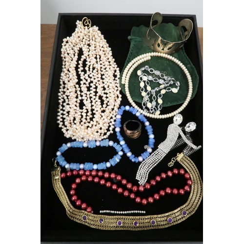 199 - An assortment of costume jewellery to include a Butler and Wilson dancer brooch and a cuff bangle st... 