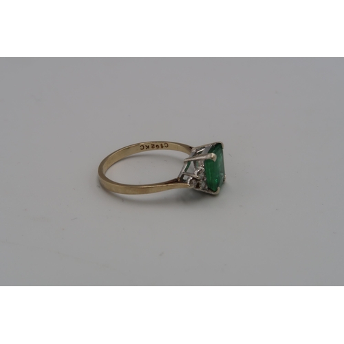 226 - A 9ct gold emerald and diamond dress ring. Emerald measuring approximately 7mm by 7.7mm. Ring size O... 