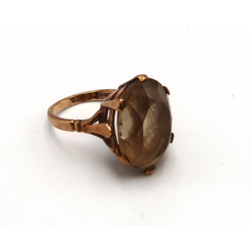 227 - A 9ct gold smokey quartz single stone ring. Size N 1/2. Weight 5.62 grams