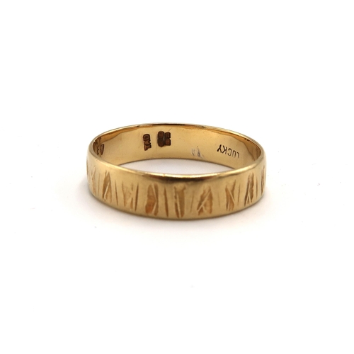 229 - An 18ct gold textured band ring. Size N. Weight 3.04 grams