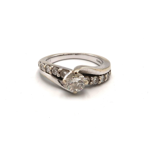 230 - An 18ct gold diamond crossover dress ring. Central diamond estimated 0.50ct. Estimated I/J colour. I... 