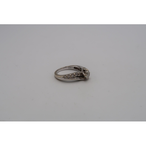 230 - An 18ct gold diamond crossover dress ring. Central diamond estimated 0.50ct. Estimated I/J colour. I... 