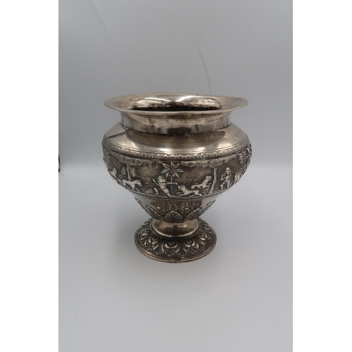 345 - An Indian white metal, likely silver vase of squat baluster form with detailed chased and repousse w... 