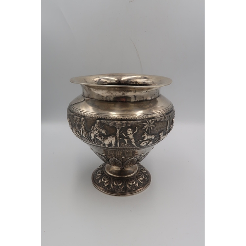 345 - An Indian white metal, likely silver vase of squat baluster form with detailed chased and repousse w... 