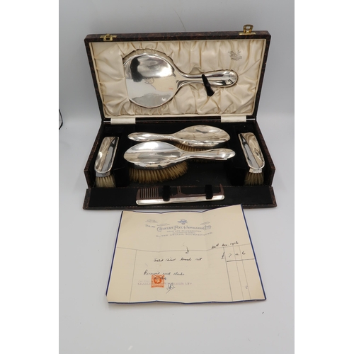 350 - A silver mounted dressing table vanity set, comprising two hair brushes, clothes brushes and comb ba... 