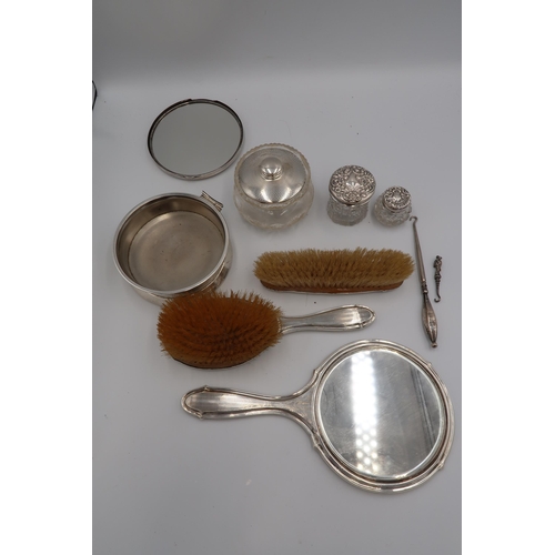 351 - A silver backed dressing table vanity set, comprising hairbrush, clothes brush and mirror, with engi... 