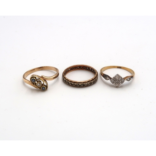 49 - Three gold rings - An 18ct gold panel ring set with six diamonds size N - a 9ct gold (tested) three ... 