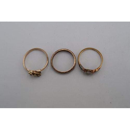 49 - Three gold rings - An 18ct gold panel ring set with six diamonds size N - a 9ct gold (tested) three ... 