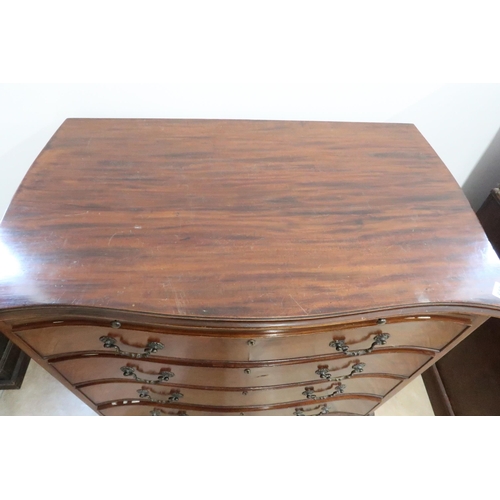 643 - A late 19th/20th century mahogany four drawer serpentine chest on bracket feet with a brushing slide... 