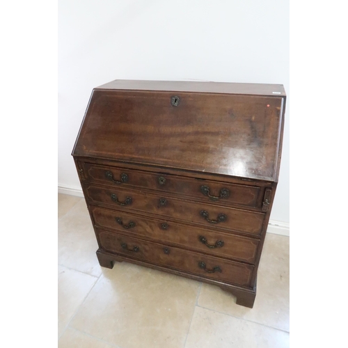 646 - A Georgian mahogany and inlaid bureau with a fitted interior over four drawers with brass swan neck ... 