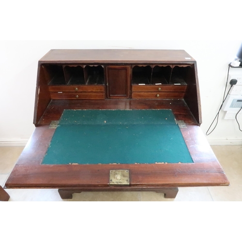 646 - A Georgian mahogany and inlaid bureau with a fitted interior over four drawers with brass swan neck ... 