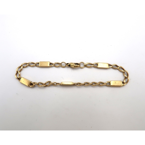 99 - A curb and panel link bracelet. Tests 18ct. Weight 16.32 grams